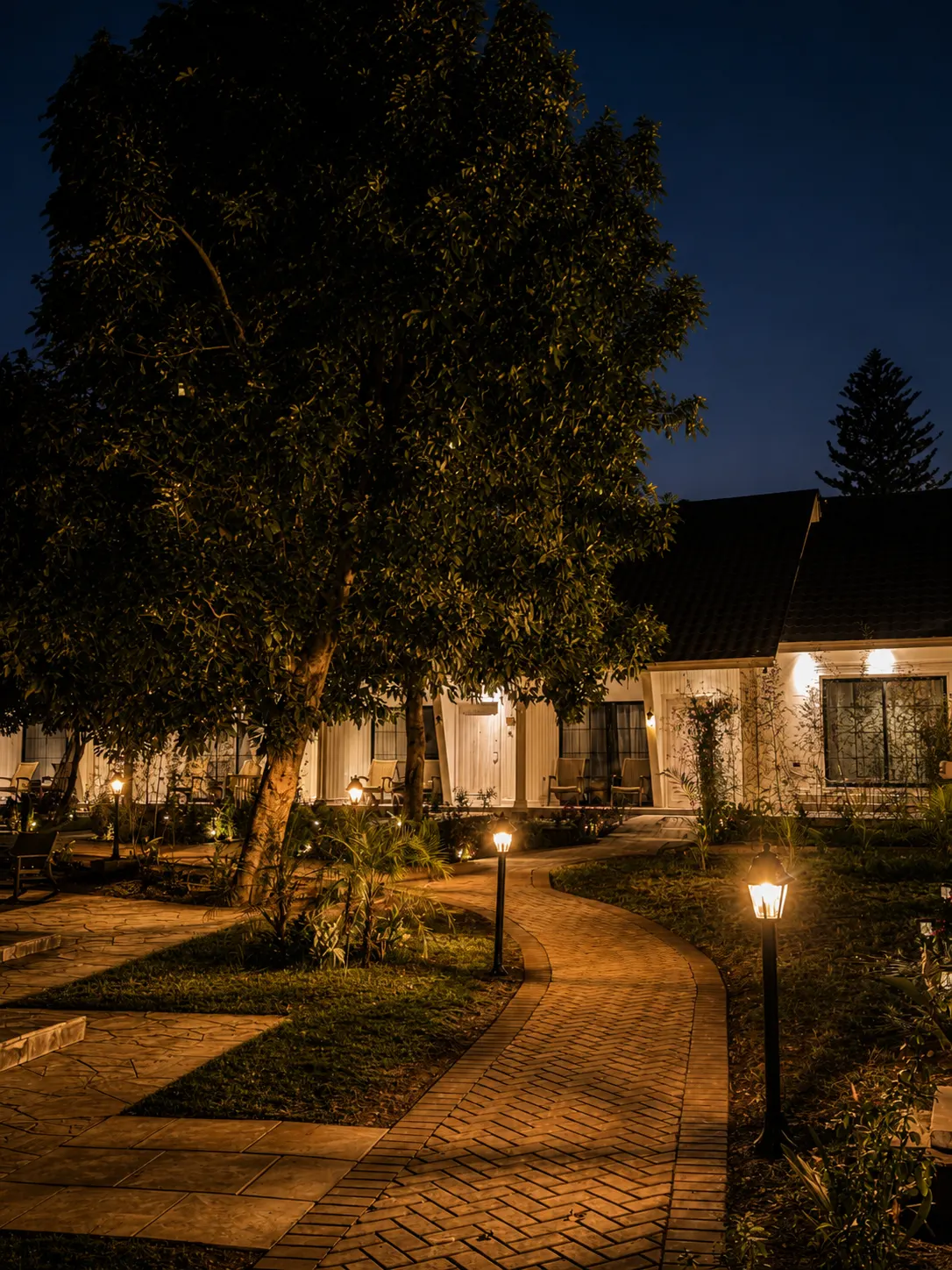 Haile Boutique Hotel garden illuminated at dusk in Arusha, Tanzania.
