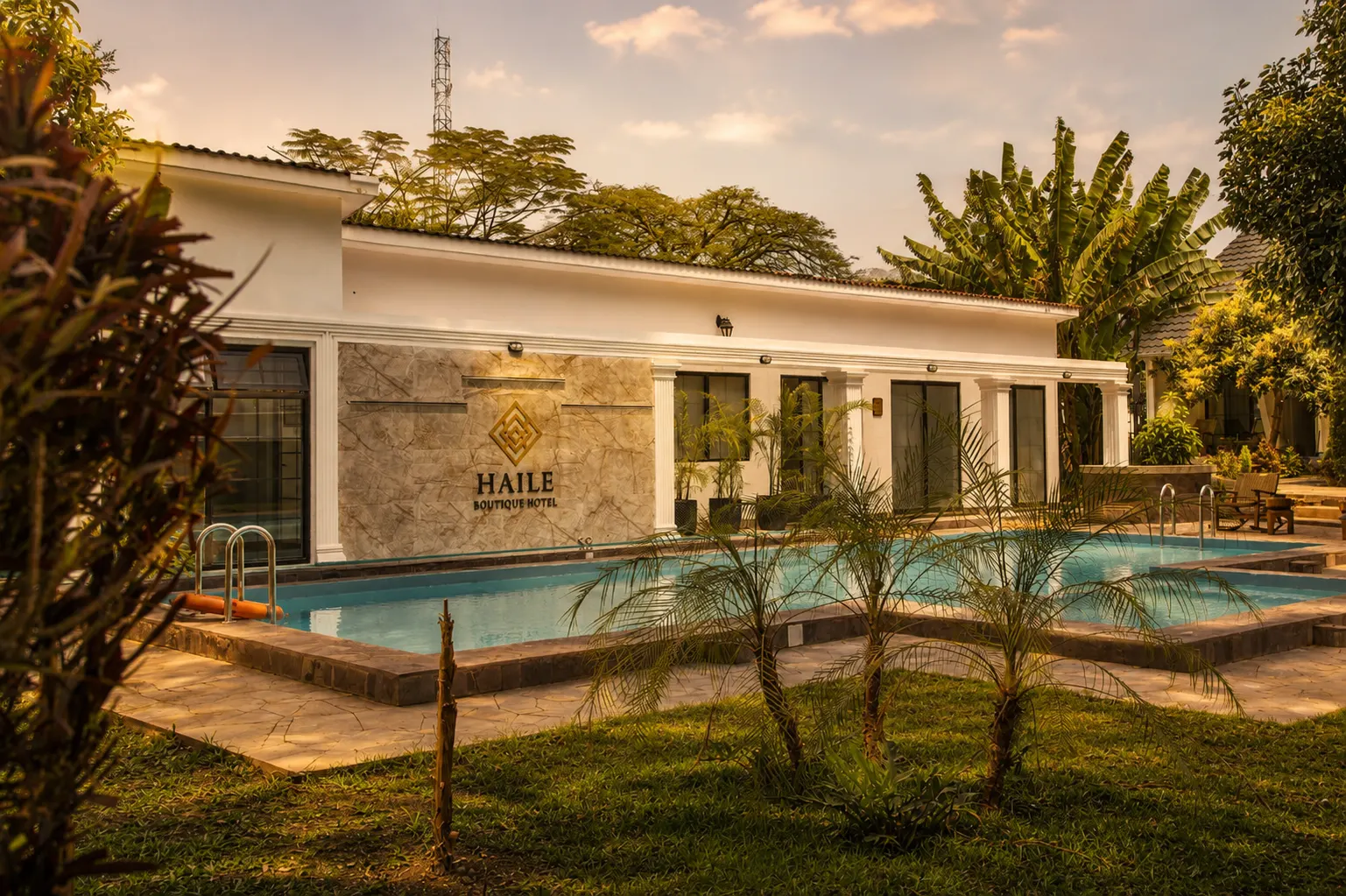 Outdoor swimming pool and garden colonnade at Haile Boutique Hotel in Arusha, Tanzania.