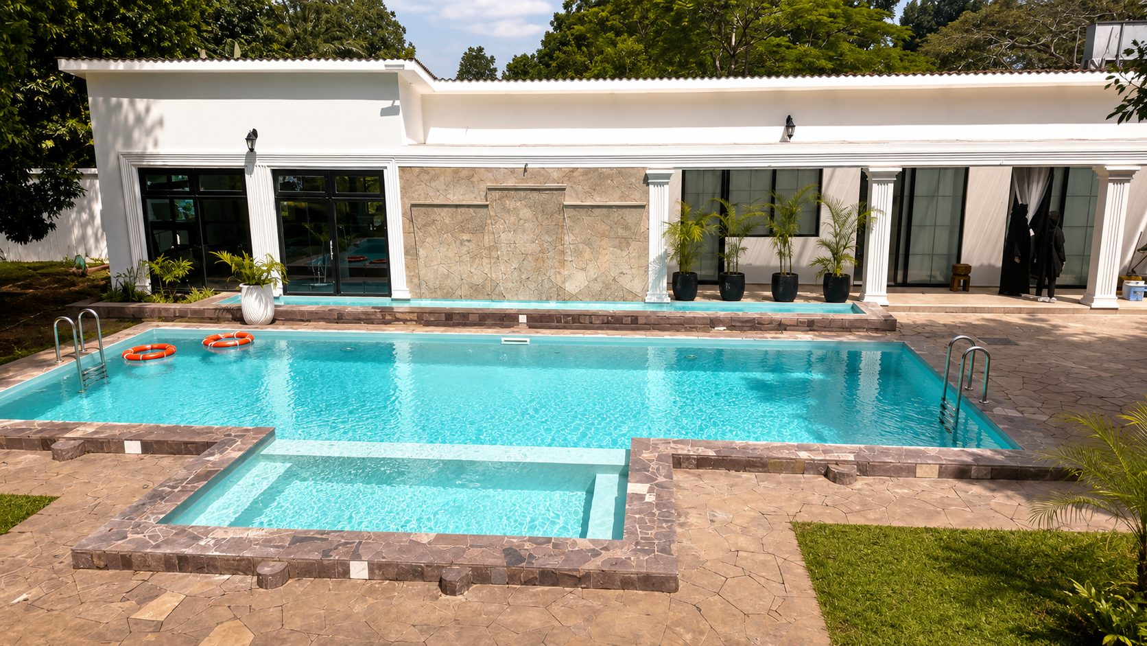 The pool and the white colonnade of the garden wing.